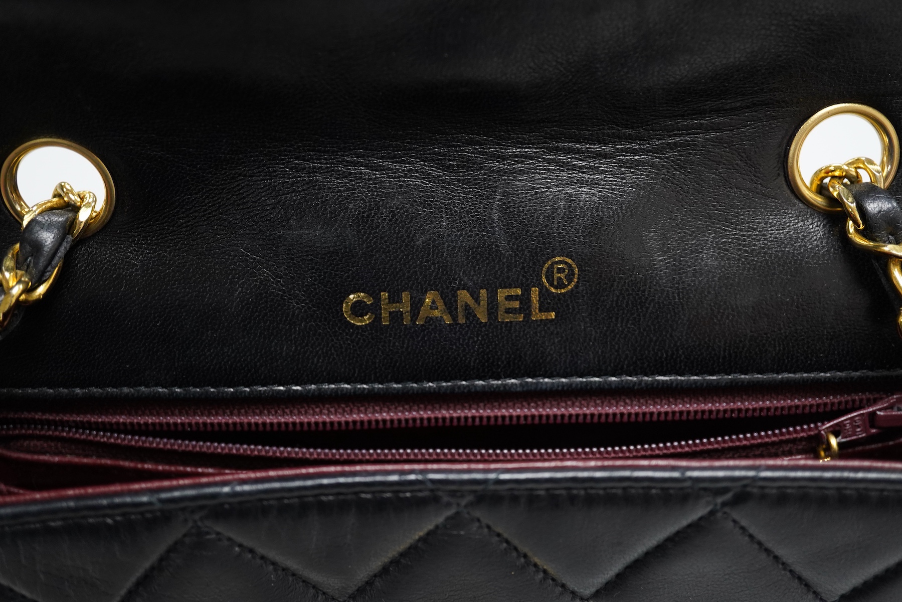 A late 1980’s Chanel black leather Diana shoulder bag with original dust cover and bag, Chanel authenticity card numbered 1944645, interior date code rubbed, 23cm wide, Provenance: Purchased by the vendor, 26 Old Bond St